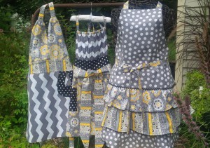 It's fun to play with fabric and style combinations. We love this set of aprons in grey and yellow coordinating prints that were a custom order for three sisters; the styles are Ellie on the left, Josephine in the center and Gigi on the right.
